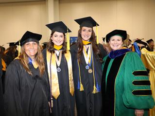 Four Graduates smiling together