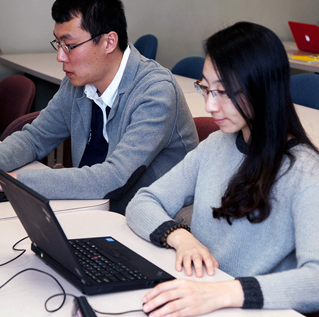 International students, man and woman, on their laptops