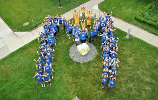 Aerial view of new students forming a big letter 'M' pattern during orientation